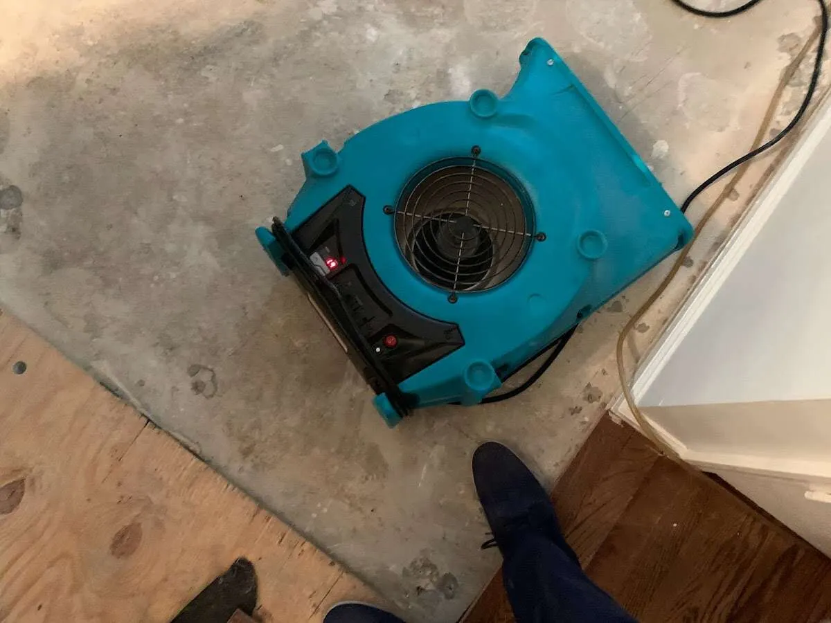 Air mover drying subfloor during Commercial Water Damage Restoration in Clarinda